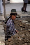Indigenous man working to repair the aging sewer system beneath the cobbled streets of Cuenca (Ecuador).