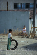 Child playing with old tire in Tena (Amazonas, Ecuador)
