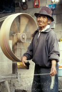 Indigenous man, spinning wool into yarn for weaving, Andean town of Peguche.