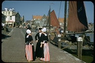 People in Dutch costumes on the wharf at Volendam, Netherlands
