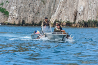 Walrus hunters by Kolyuchin Island with two dead walrus tied to their boat.