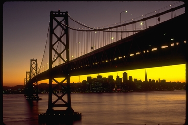 View of the Bay Bridge and the San Francisco skyline at sunset