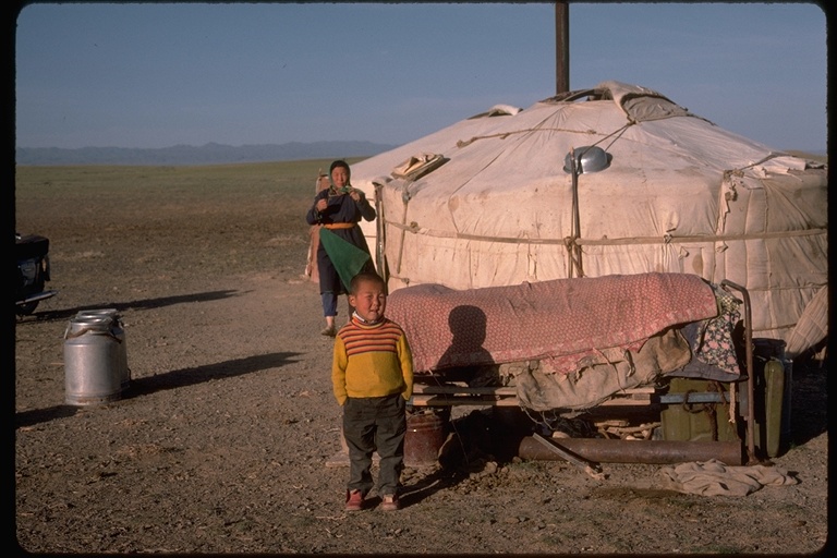 Family in front of yurts in the Gobi Desert, Mongolia, 1976