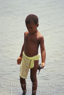 Garifuna boy playing in the shallows in Punta Gorda.