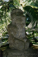 Stone Tiki statue in the forest.