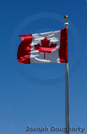 Canadian flag in stiff breeze.