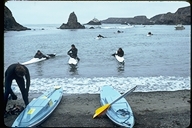 Kayaks returning to beach in Albion in Mendocino County, California