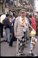 A Busker in button-covered costume in London, England