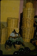 Market vendor with baskets, Mexico