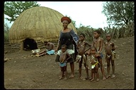 Zulu woman and children in front of a traditional house in the Province of Natal, South Africa, 1975