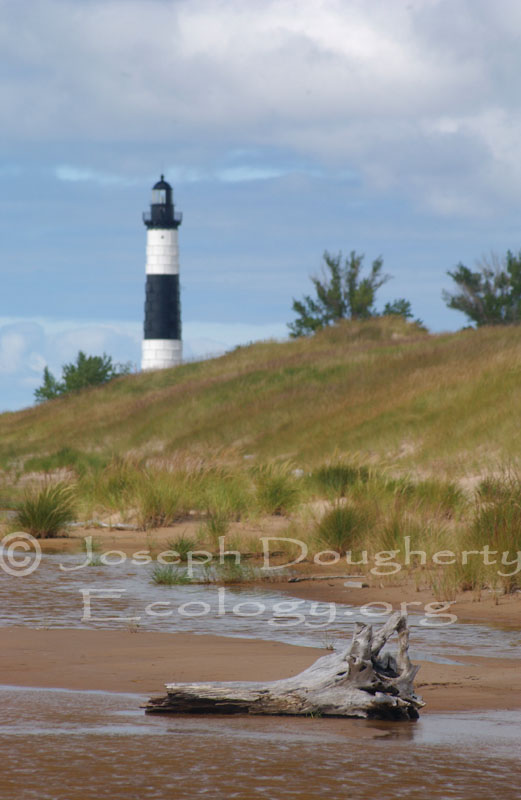 Big Sable Point Lighthouse stands behind sand dunes on the eastern shore of Lake Michigan.