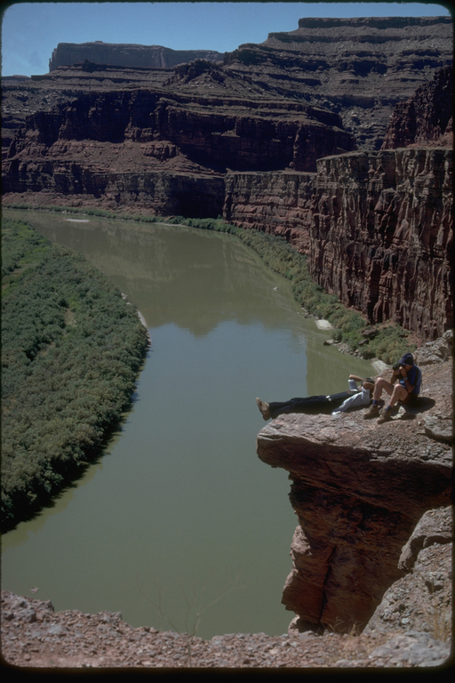Hikers resting on cliffs along the Green River, Utah Hikers resting on cliffs along the Green River, Utah