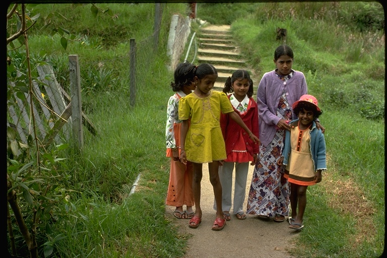 Women and children wearing colorful clothing near research station in Malaysia Women and children wearing colorful clothing near research station in Malaysia