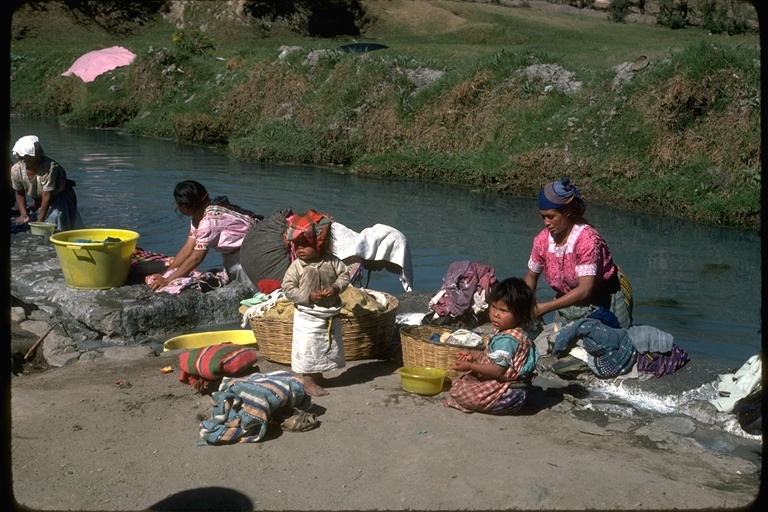 Women washing clothing in a stream in Guatemala