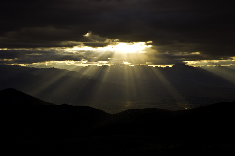 Crepuscular Rays and Sunset thru the clouds from the White Mountains looking toward the Sierra Nevada Mountains in California