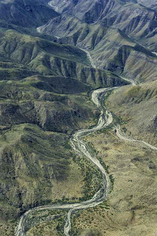 Geologic features of Baja California Norte from an airplane showing erosion, valley