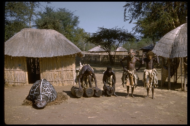 Turtle effigy and drummers in African village, Africa Turtle effigy and drummers in African village, Africa